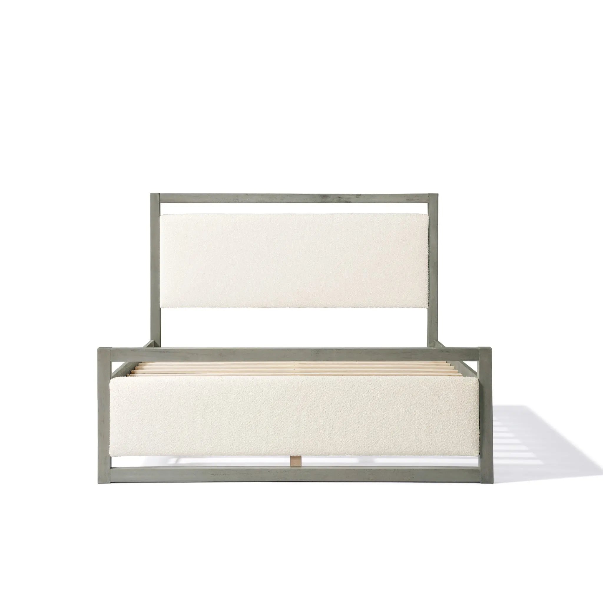 A minimalist gray bed frame complements a chic white boucle headboard and footboard, perfect for a modern bedroom aesthetic.
