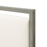 Close-up of a beige upholstered headboard with a sleek gray bed frame, perfect for a modern bedroom.