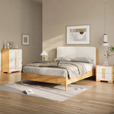 A modern bedroom features a sleek rubberwood platform bed with gray bedding, flanked by two matching nightstands and a dresser. An upholstered headboard adds contemporary visual dimension, while a framed abstract artwork hangs above. A plant stands gracefully in the corner.