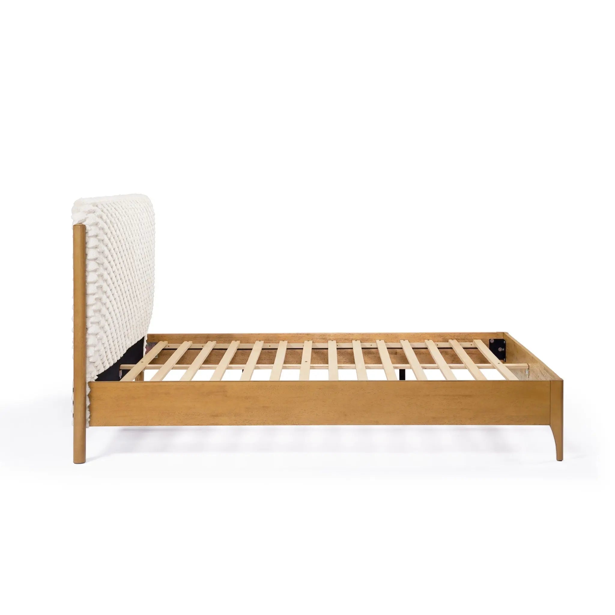 Side view of a Rubberwood Platform Bed featuring an upholstered, textured headboard and slatted base, adding a contemporary visual dimension to any bedroom.