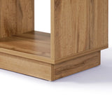 Close-up of the lower corner of a wooden shelf with a light walnut finish, highlighting its wood grain texture and clean lines.