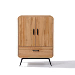 Walnut oak finish wooden cabinet with two doors and a lower drawer, featuring black metal handles and legs, embodies mid-century modernism.