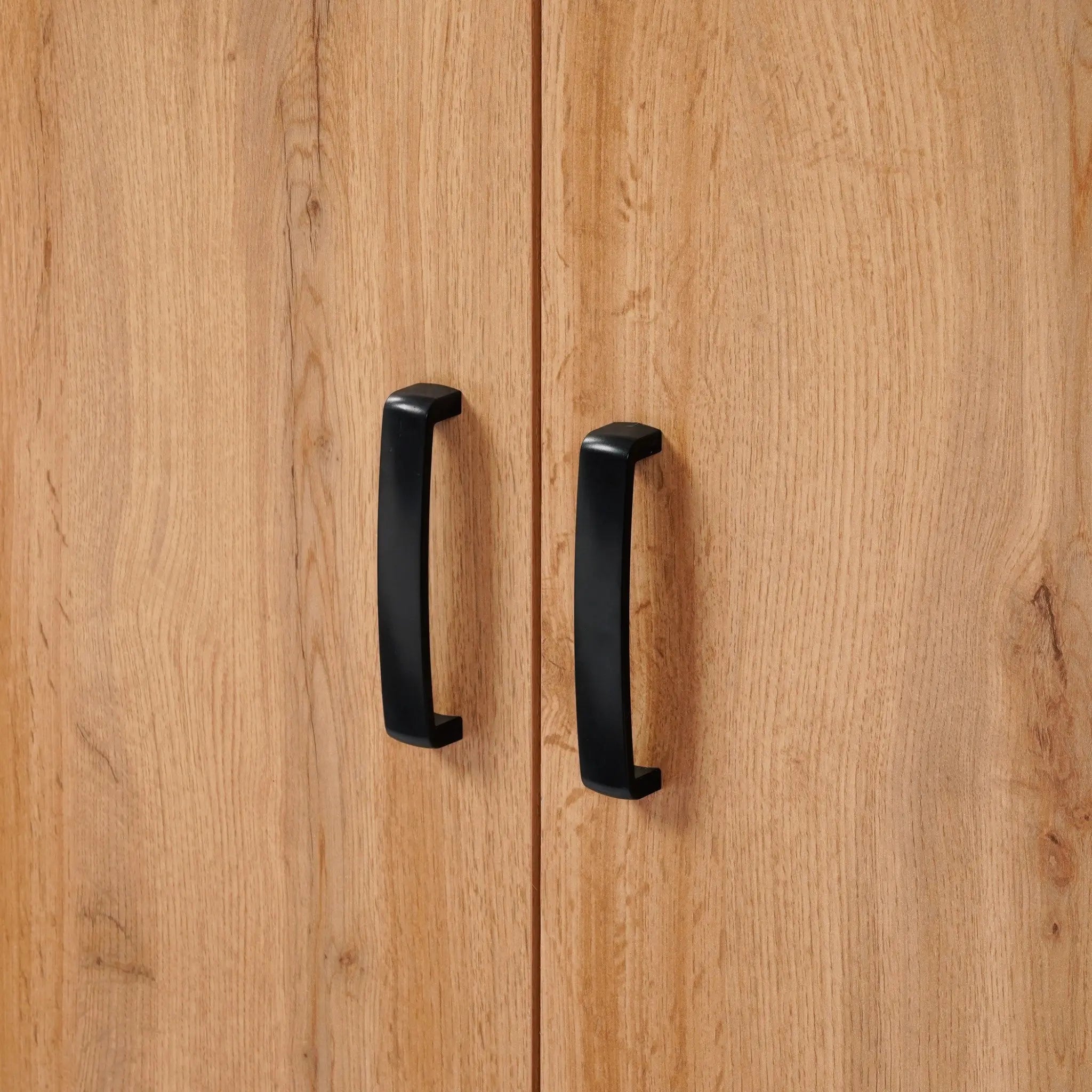 A freestanding cabinet featuring wooden doors, enhanced by sleek black handles, embodies mid-century modernism with its elegant walnut oak finish.