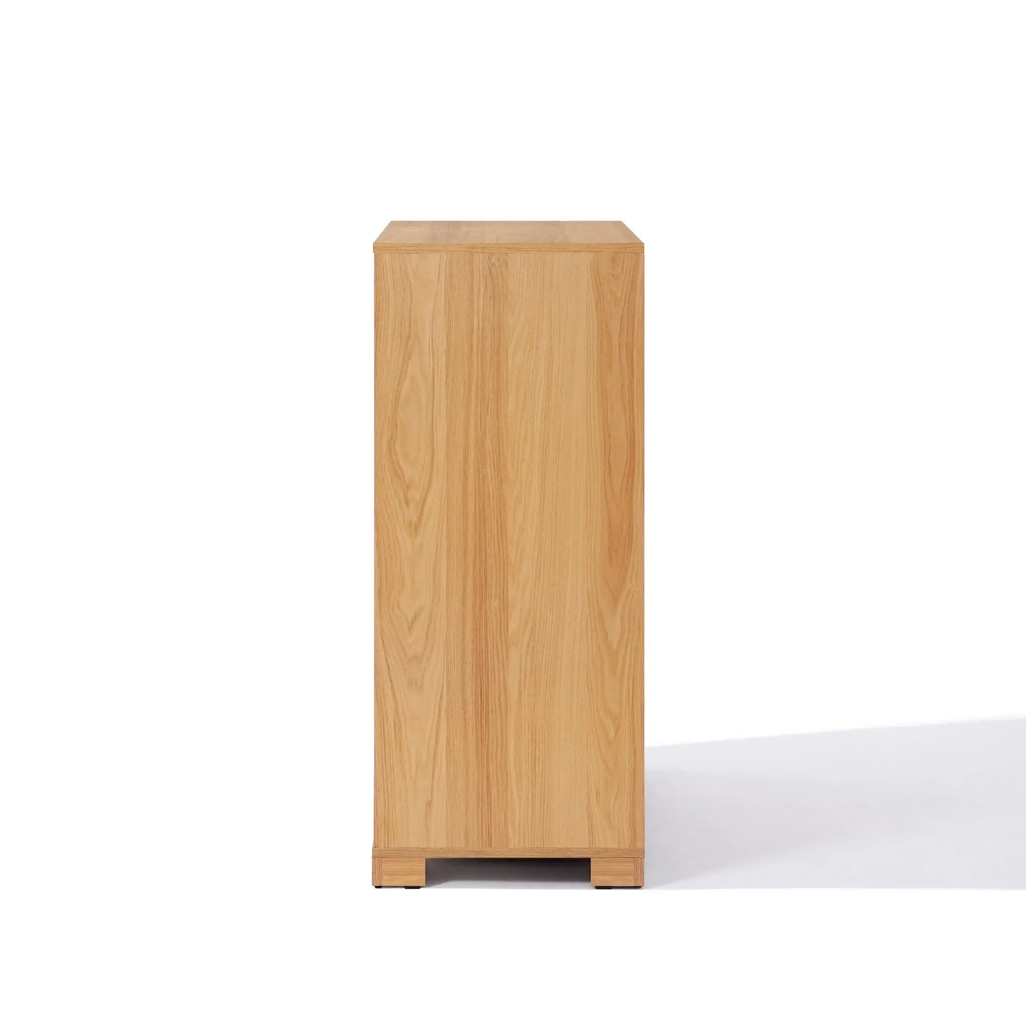 A wooden 4-drawer chest viewed from the side against a white background, perfectly blending style and functionality as a mid-century modern storage solution.