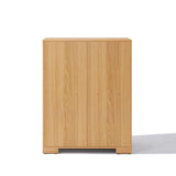 This wooden cabinet, with its minimalist flair, features two doors and a light oak finish, seamlessly blending into any space as an ideal storage solution inspired by mid-century modern design.