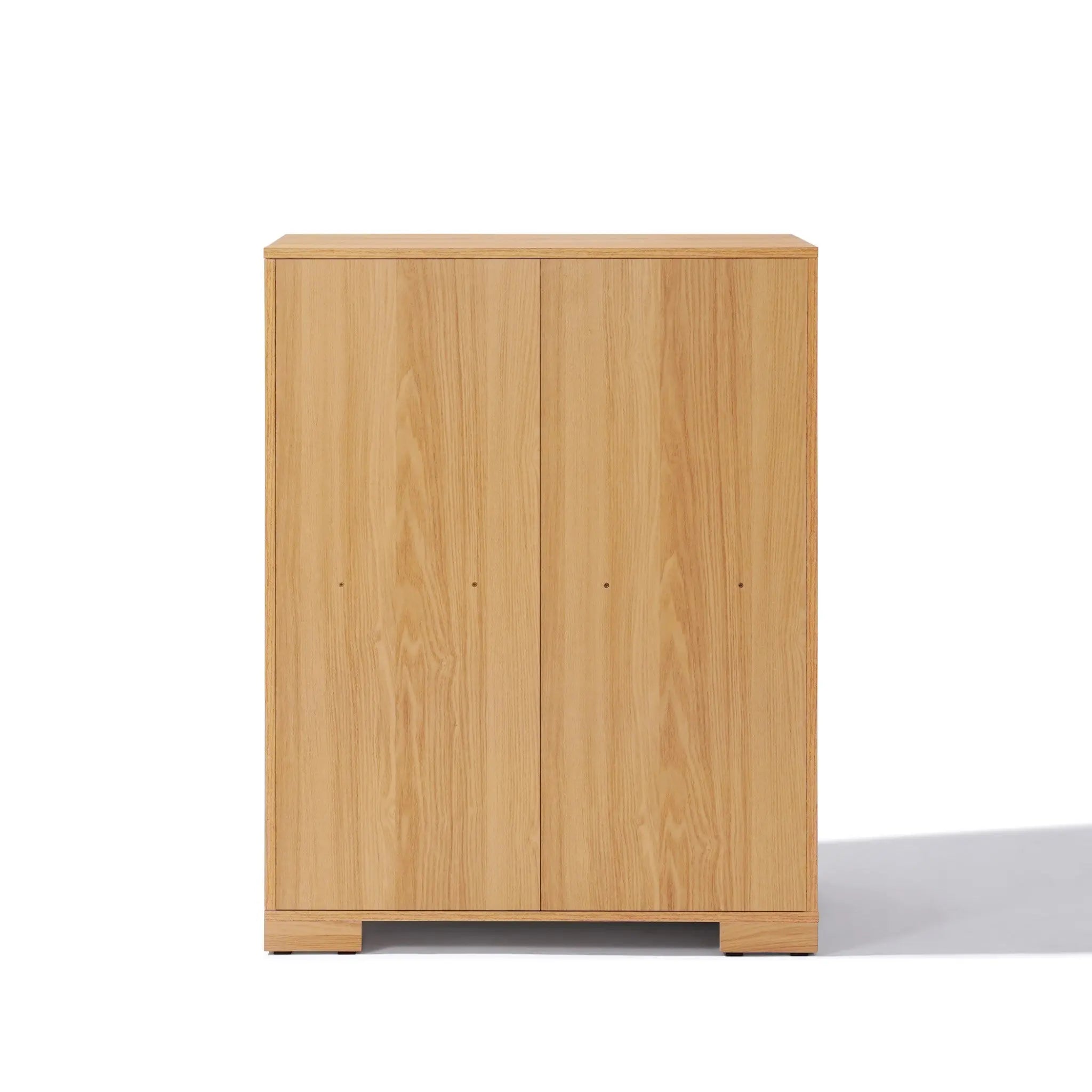This wooden cabinet, with its minimalist flair, features two doors and a light oak finish, seamlessly blending into any space as an ideal storage solution inspired by mid-century modern design.