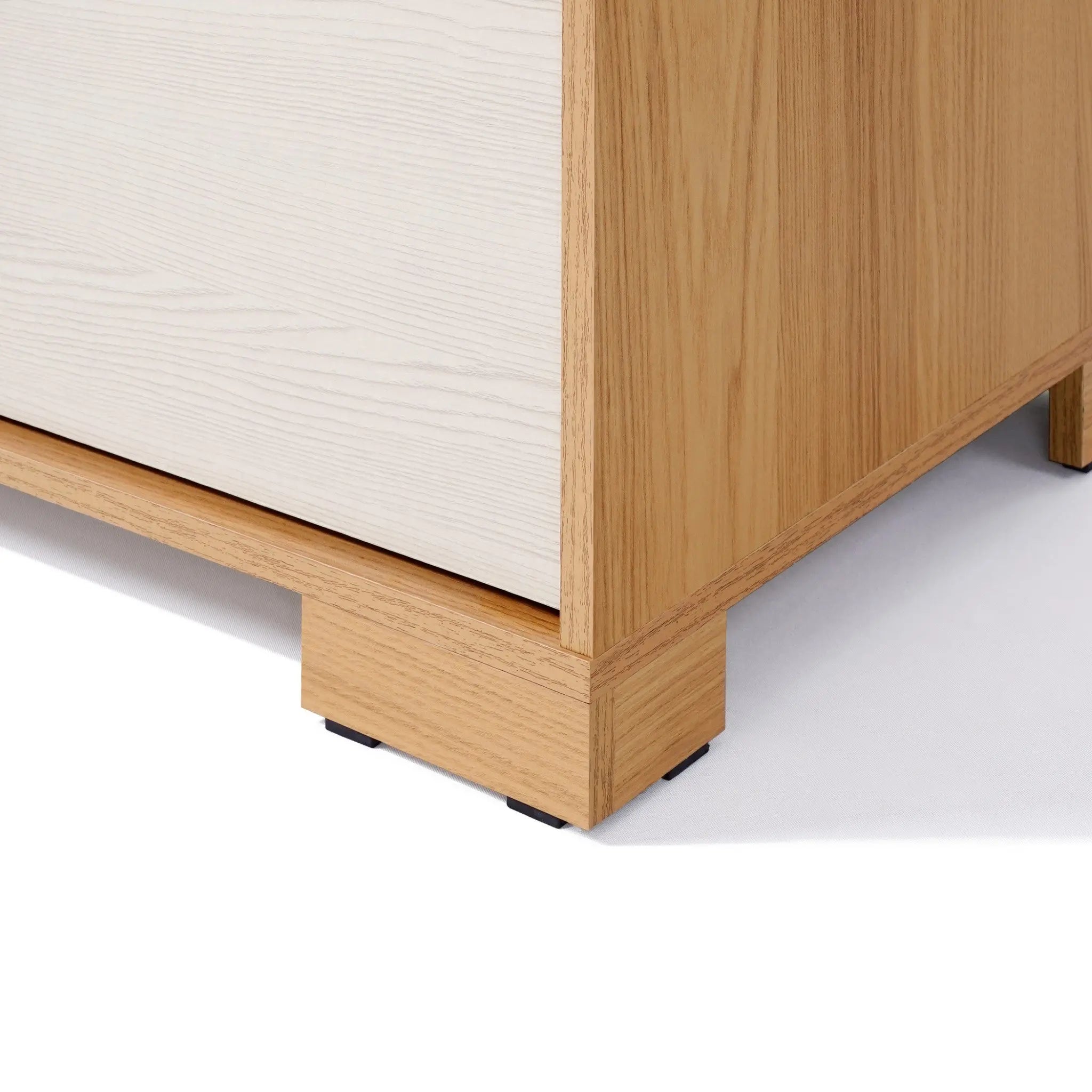 Close-up of a wooden furniture corner on a white background, showcasing light wood grain and a simple, minimalist design reminiscent of mid-century modern design.