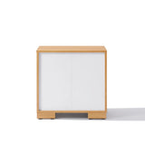 A charming wooden nightstand with a single white sliding door and minimalistic design, offering ample storage while retaining a clean look when viewed from the front.