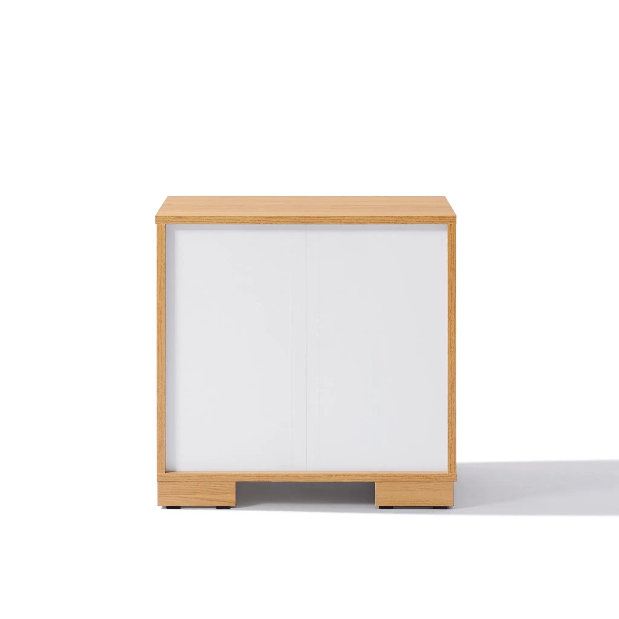 A charming wooden nightstand with a single white sliding door and minimalistic design, offering ample storage while retaining a clean look when viewed from the front.