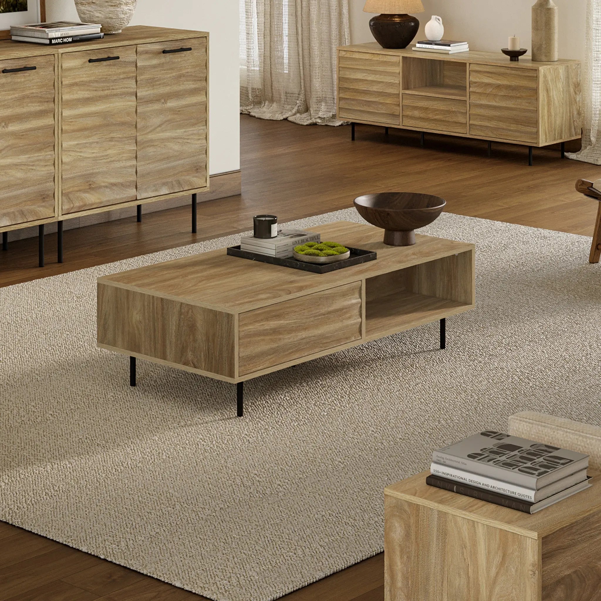 A living room adorned with mid-century modern wooden furniture, featuring a stylish coffee table on a beige rug. Decor includes a wooden bowl, trays, books, and vases. Neutral-colored curtains and a lamp complete the serene backdrop.