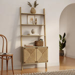 A LuxenHome Kaia rope & wood finish etagere bookcase with decorative items, including a potted plant and framed artwork, stands next to an archway. Below is a geometric designed 2-door cabinet. A wooden chair is partially visible on the left.