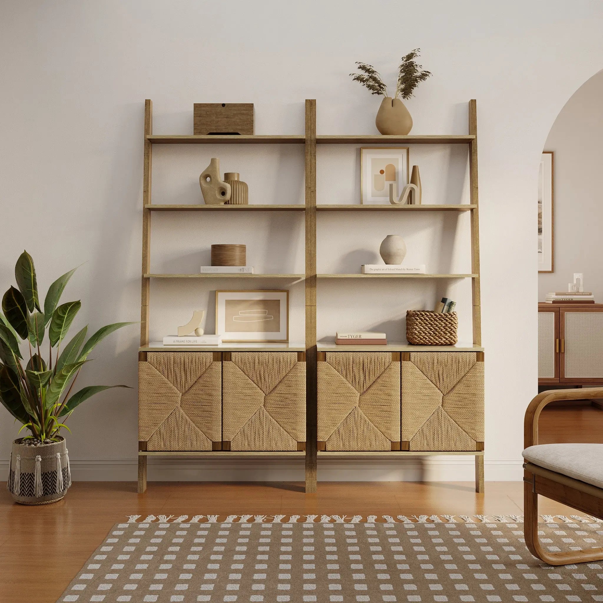The LuxenHome Kaia rope & wood finish etagere bookcase, featuring a 2-door cabinet, elegantly displays vases, plants, and books. A potted plant is next to the 4-shelf bookcase on a patterned rug covering the wooden floor in a well-lit living room.