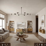 A cozy living room features a round wooden coffee table, gray sofa, and the LuxenHome Kaia rope & wood finish etagere bookcase with a 2-door cabinet. Neutral tones, wall art, plants, and decor add warmth. A modern chandelier stylishly illuminates from the ceiling.
