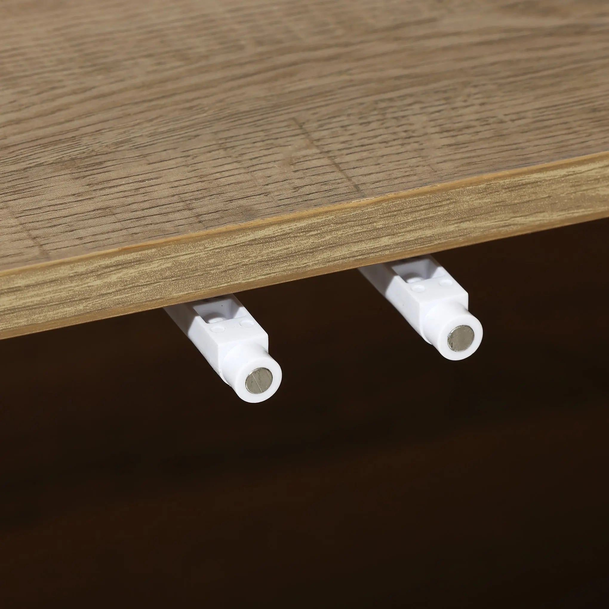 Close-up of two white shelf pegs protruding from a wooden board, perfectly complementing the mid-century modern aesthetic.