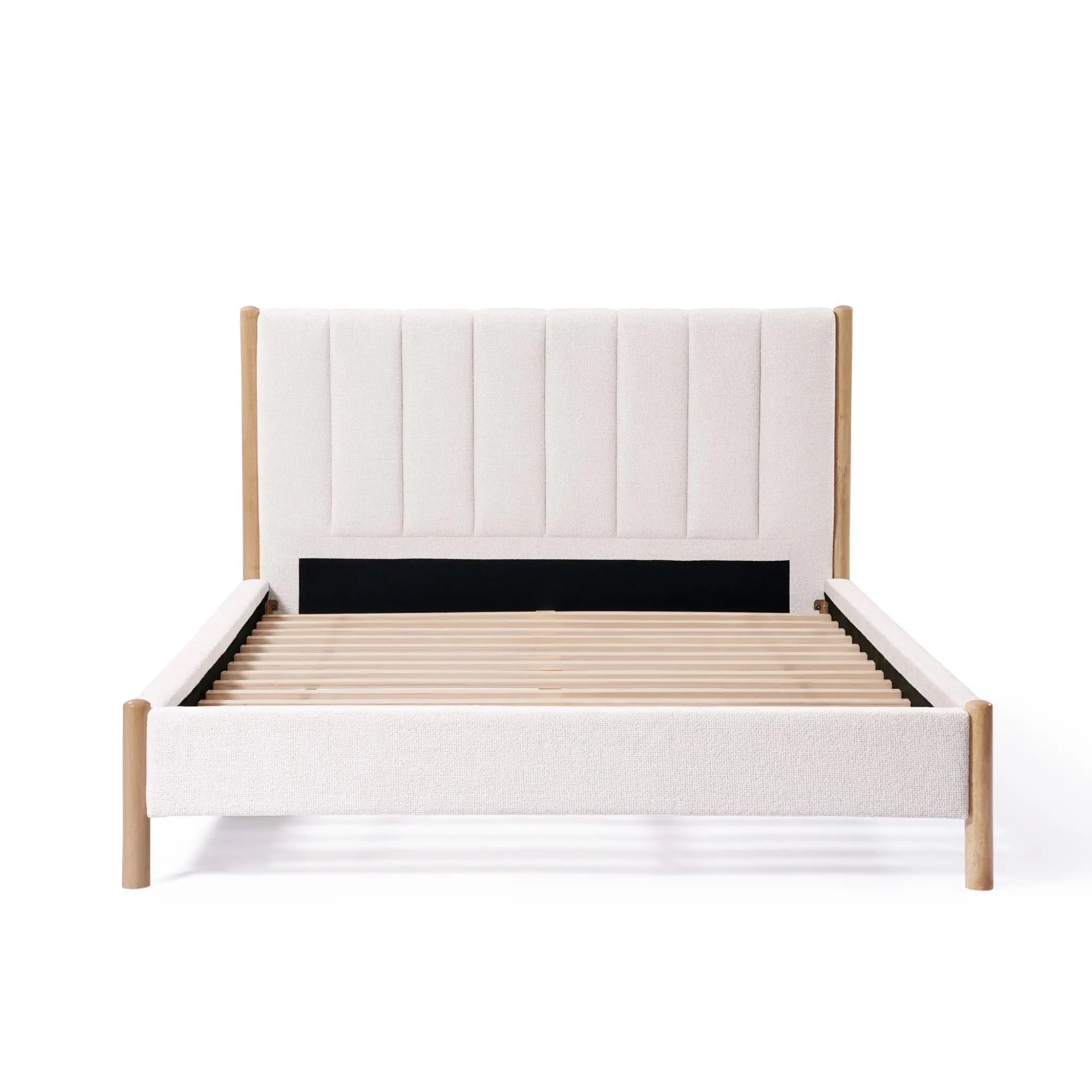 A minimalist rubberwood platform bed features a queen-sized, beige boucle headboard with subtle vertical stripe design, complemented by light wood accents.