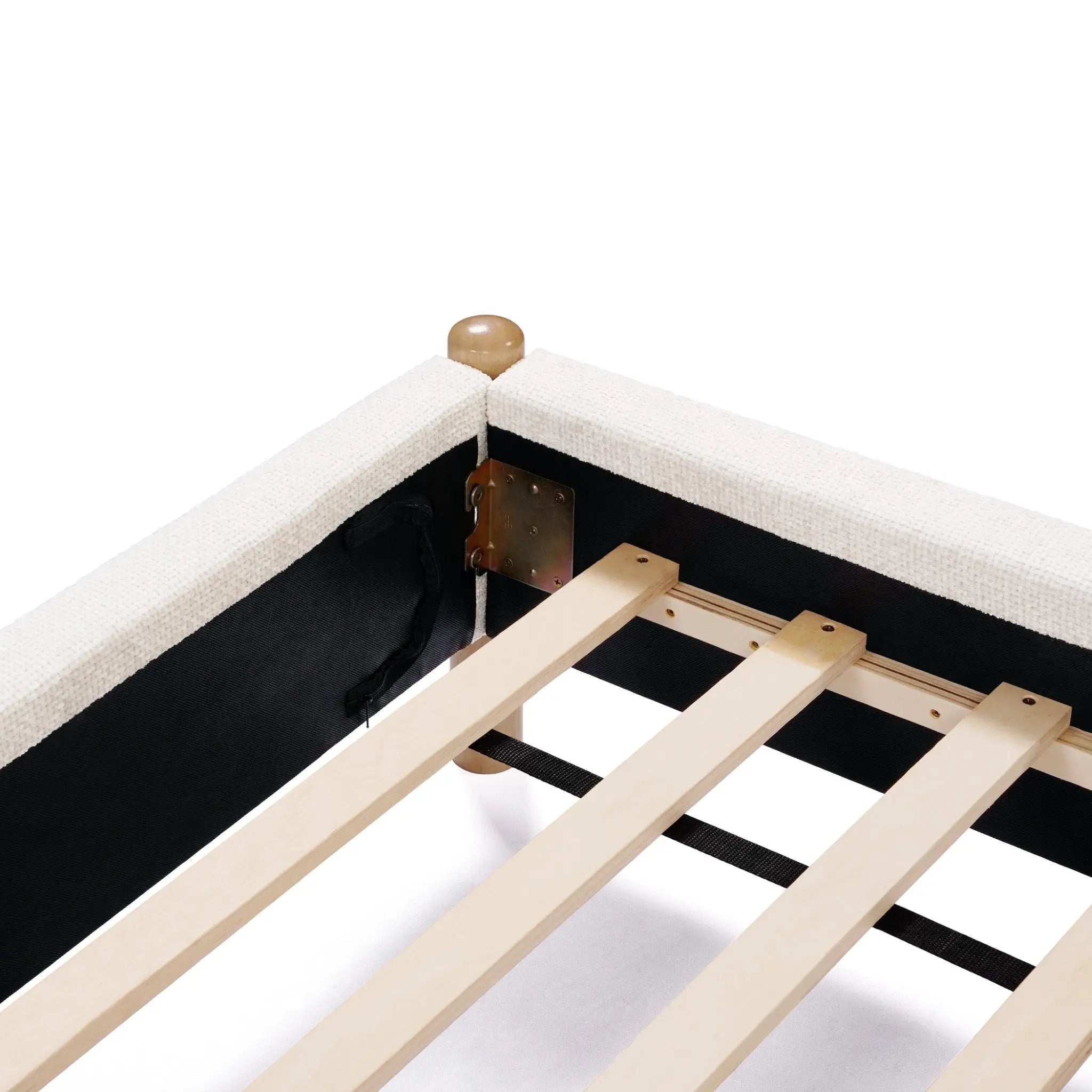 A close-up of a bed frame showcases corner assembly with a beige fabric cover, wooden slats, and a metal bracket, highlighted by its vertical stripe design.