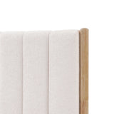 Close-up of a queen-sized white boucle headboard featuring vertical stitching and a wooden corner post, perfectly complementing a rubberwood platform bed.