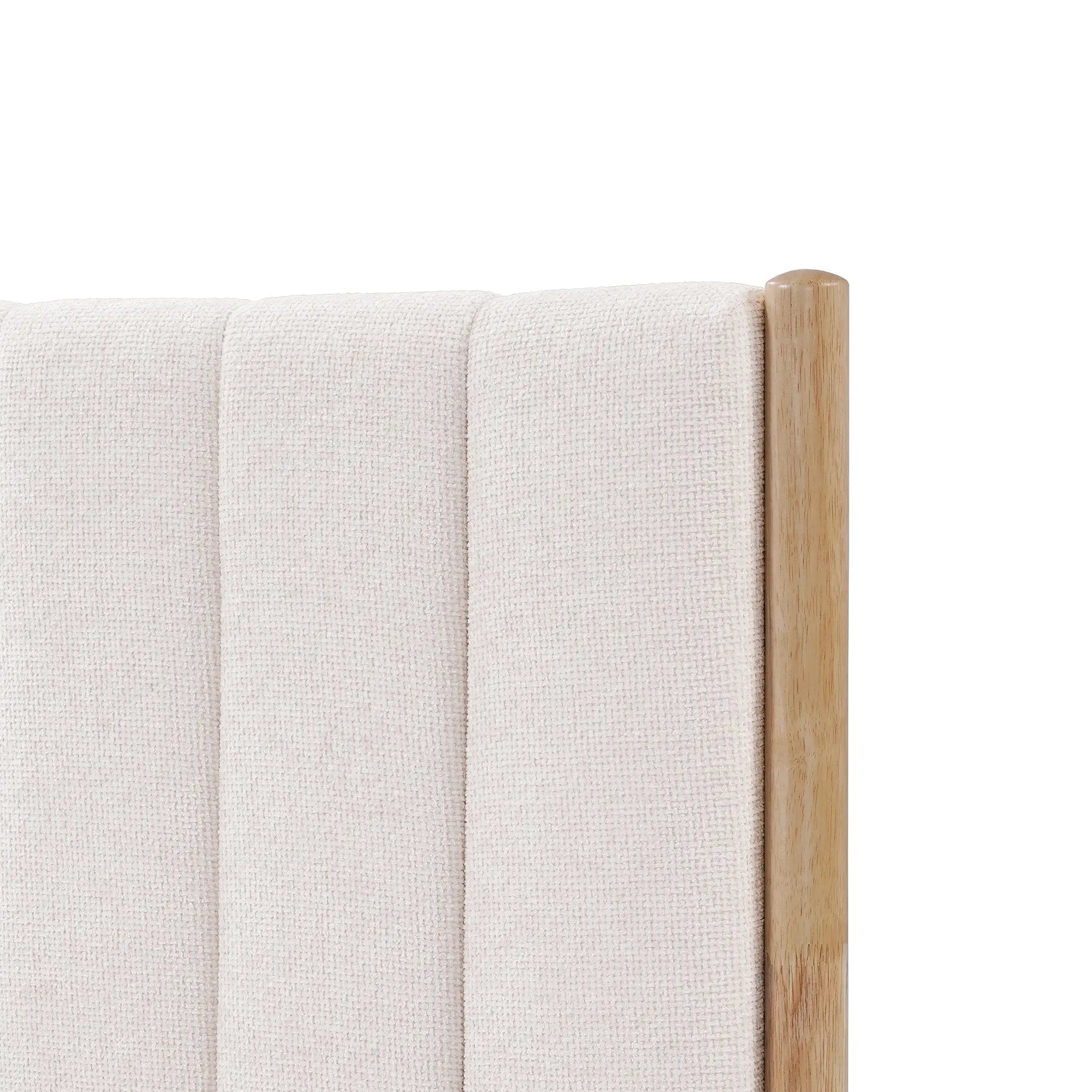 Close-up of a queen-sized white boucle headboard featuring vertical stitching and a wooden corner post, perfectly complementing a rubberwood platform bed.