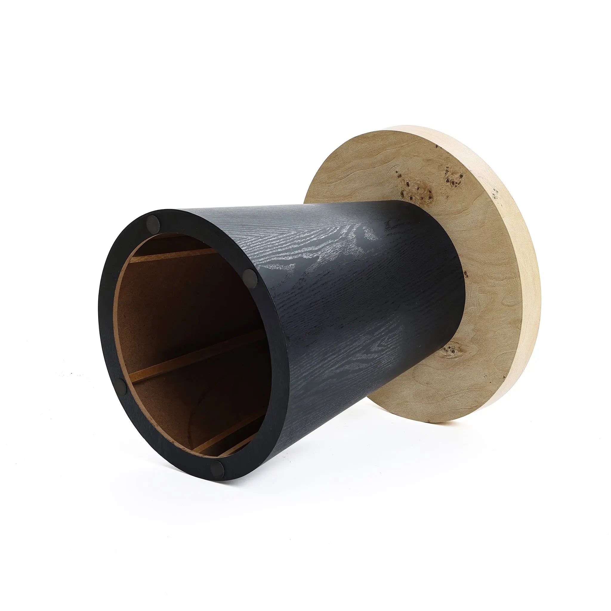 A cylindrical wooden object with a black surface on the sides and natural wood on the top and base, resembling tree burl texture, lying on its side against a plain white background.