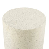 A close-up view of a cylindrical object with a smooth, speckled beige surface, likely made of stone or concrete, perfect as a modern patio table for contemporary design in outdoor furniture.