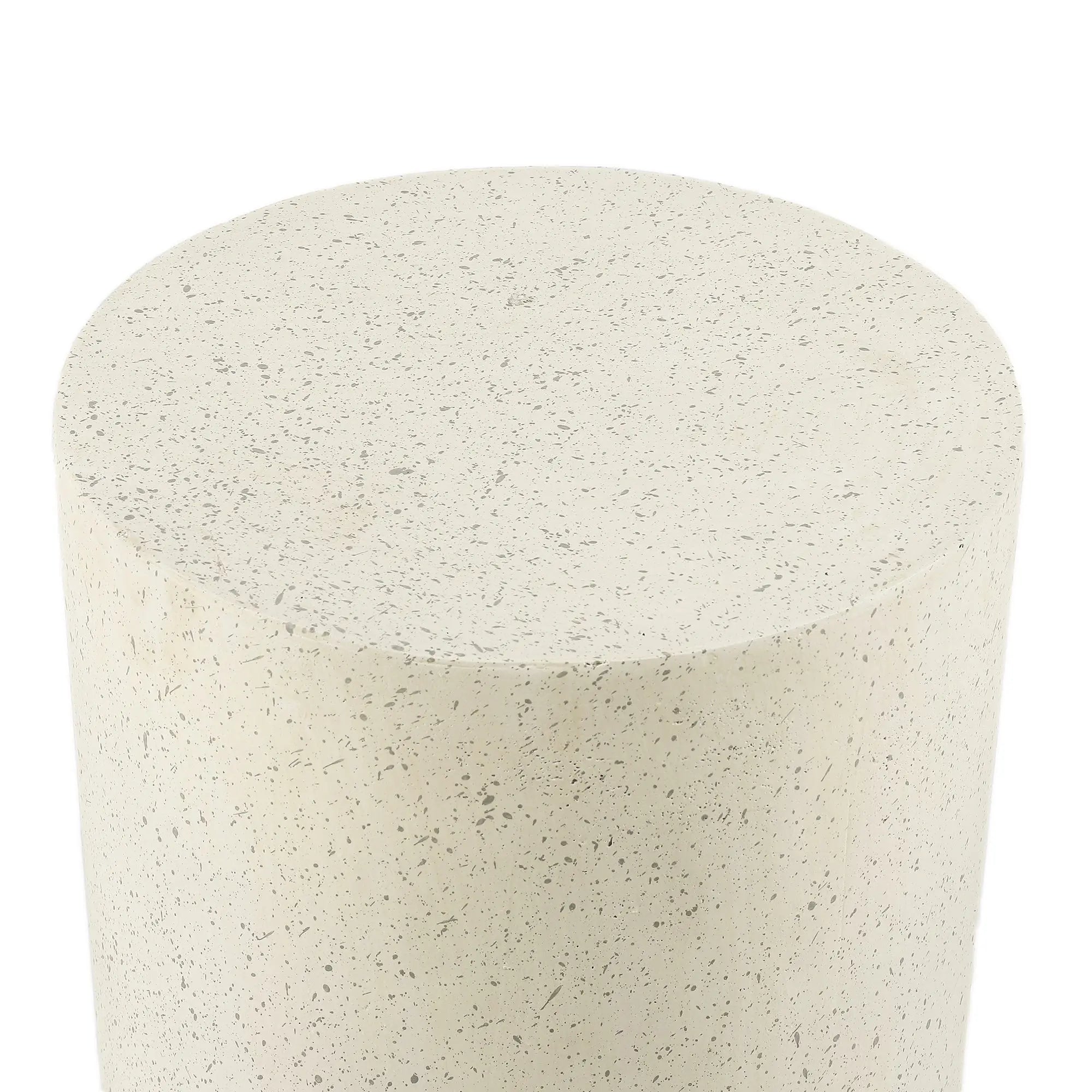A close-up view of a cylindrical object with a smooth, speckled beige surface, likely made of stone or concrete, perfect as a modern patio table for contemporary design in outdoor furniture.