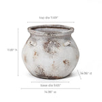 The LuxenHome Antique Cauldron Planter is a round ceramic pot with a weathered white and brown finish and two small handles. Made from magnesium oxide, it measures 11.81 H x 14.96 W/D, with a top diameter of 11.69 and base diameter of 9.65.