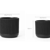Two sleek black cylindrical planters crafted from magnesium oxide material come with precise measurements. One stands 17.1 inches tall by 17.3 inches in diameter and features a convenient drainage hole, while the other is 13.6 inches tall by 14.8 inches in diameter, perfect for modern spaces.