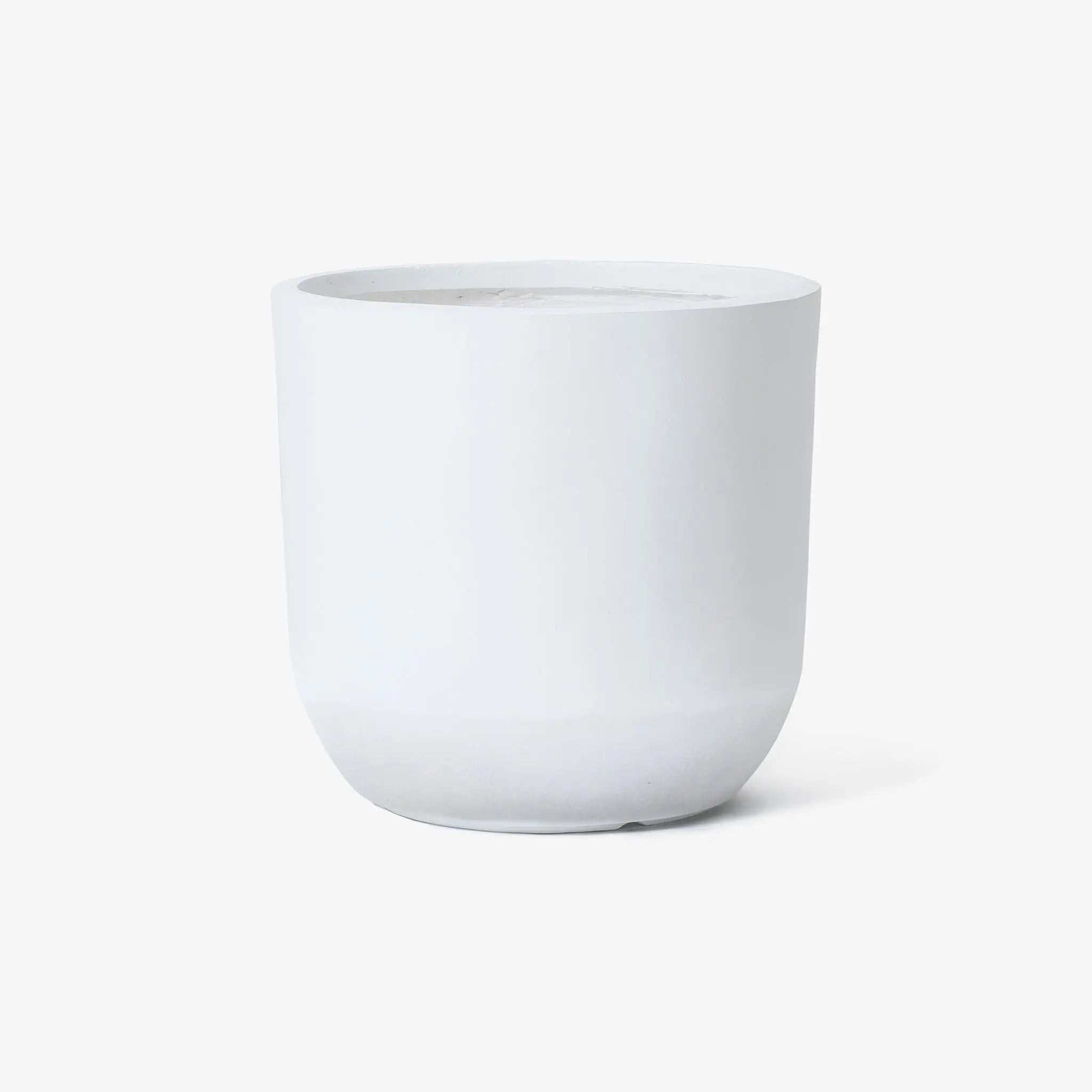 A contemporary, white ceramic planter featuring a minimalist design with a rounded base set against a white background.