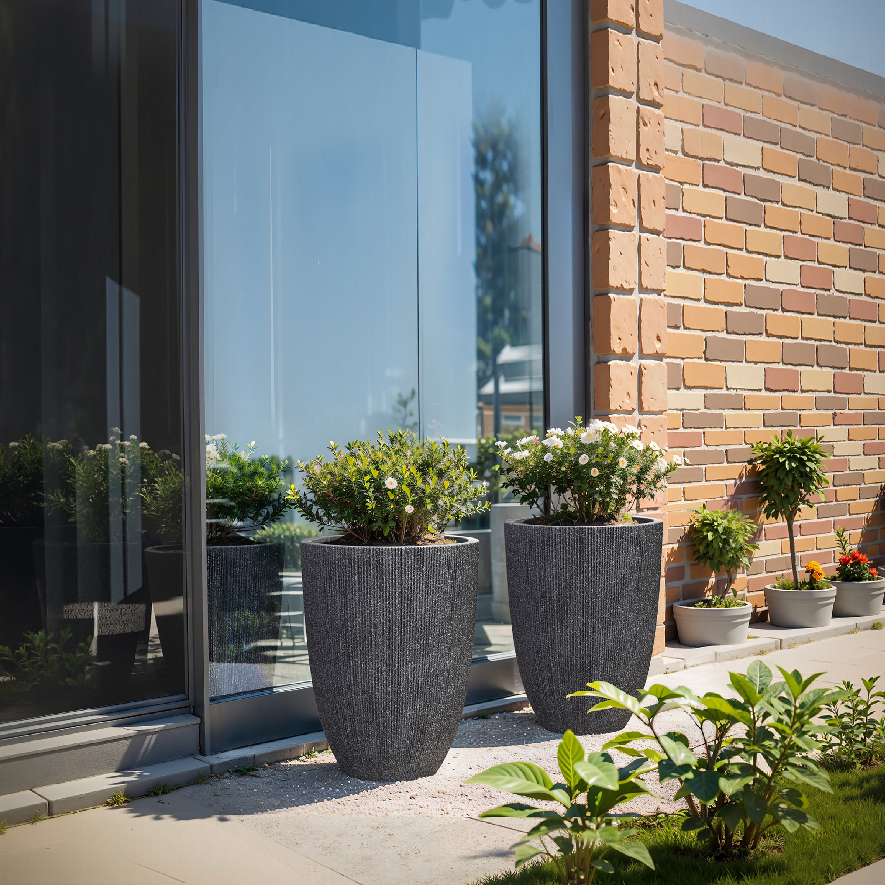 black outdoor plant pots LuxenHome 2-Piece Mediterranean Black Tall Tapered Round Plastic Planters Set