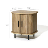 The Aria oak finish nightstand by LuxenHome features a slatted sliding door and rounded edges. It includes sleek black handles and stands on four short legs, measuring 15.75 wide, 17.72 deep, and 18.9 tall—an elegant addition to your bedroom decor.