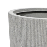 Close-up of a textured, gray cylindrical planter with a modern striped pattern and ribbed surface, showing the upper rim—a perfect addition to any home and garden.
