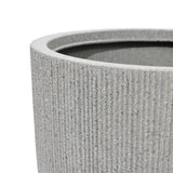 Close-up of a textured, gray cylindrical planter with a modern striped pattern and ribbed surface, showing the upper rim—a perfect addition to any home and garden.