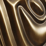 A close-up of a smooth, shiny bronze sculpture reveals swirling, curved grooves crafting a mesmerizing 3D abstract design perfect for modern home decor.