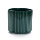 The LuxenHome Jade green ribbed glazed round ceramic planter, 11.81 h, features vertical ridges and a glossy finish. This cylindrical planter with a drainage hole embodies the Modern Plant Paradise aesthetic against a plain white background.