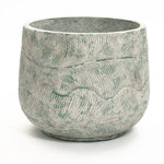 The LuxenHome Rustic Multi-Color Cement 14-Inch Round Planter features a natural stone finish with wavy engraved patterns and subtle greenish hues, creating an earthy, weathered aesthetic.