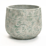 The LuxenHome Rustic Multi-Color Cement 14-Inch Round Planter features a natural stone finish with wavy engraved patterns and subtle greenish hues, creating an earthy, weathered aesthetic.