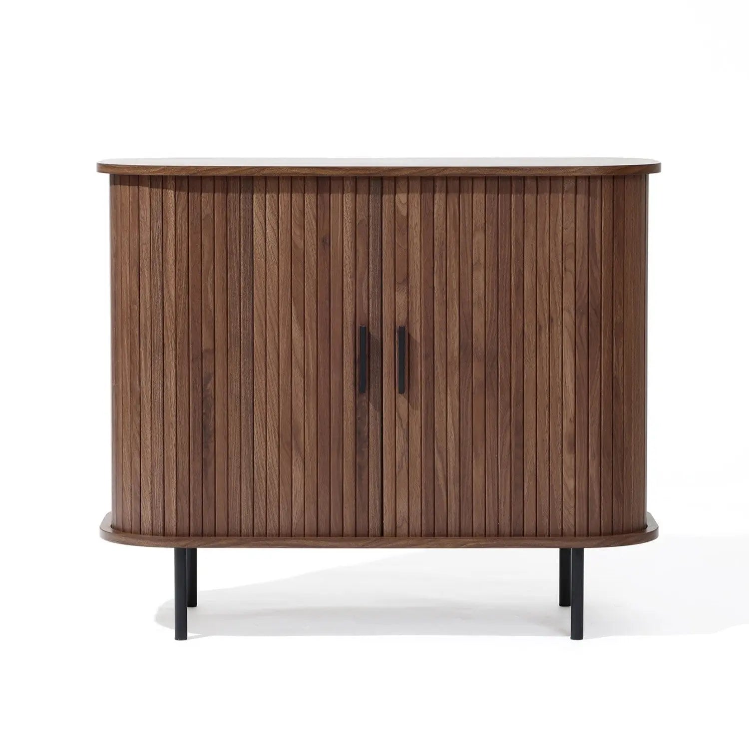 The Aria by LuxenHome is a Mid-Century Modern accent cabinet featuring tambour doors and two black metal handles. It boasts a dark oak finish with a curved front atop four slender black legs, enhancing its elegant design.