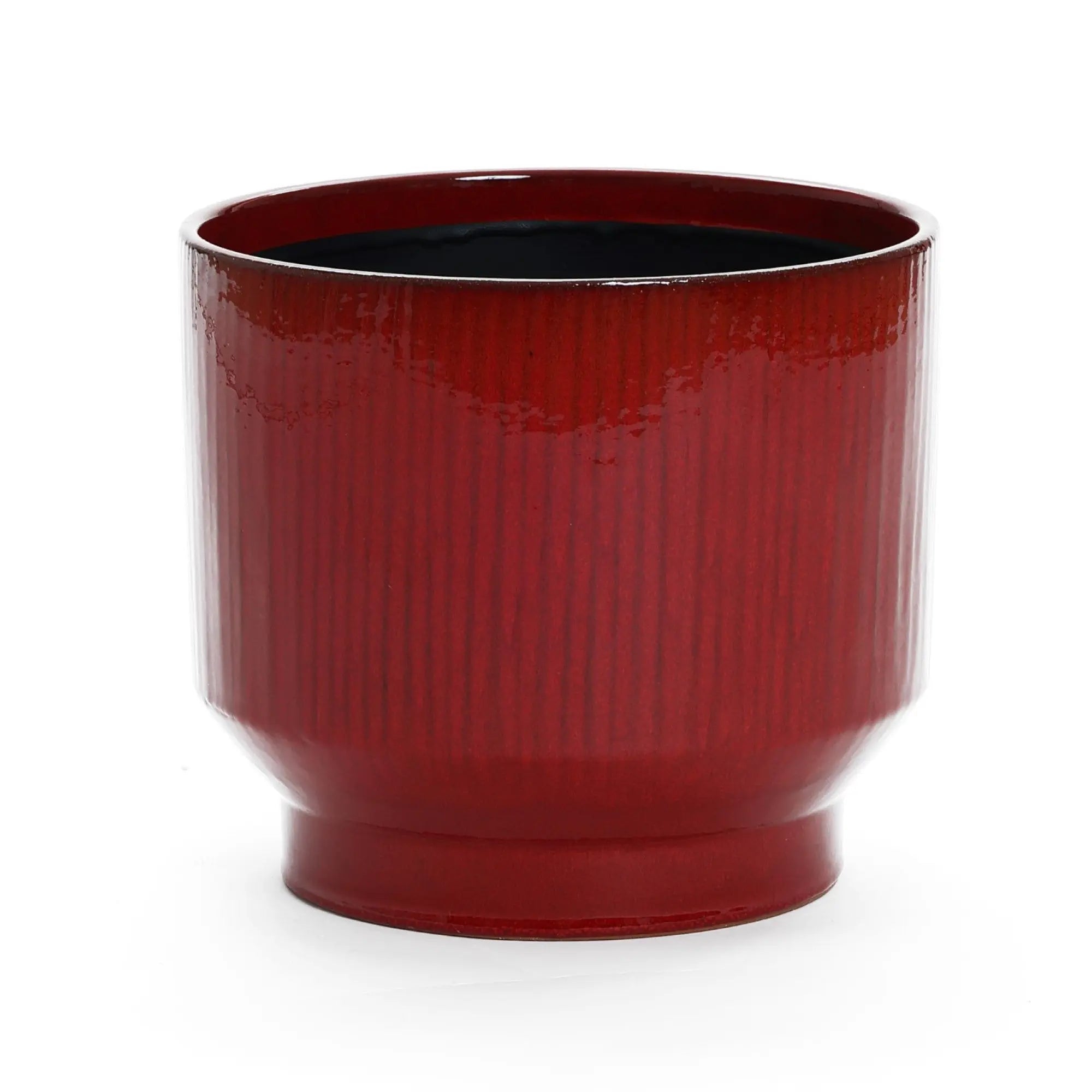 The LuxenHome burgundy red glazed round ceramic planter, measuring 10.83 in height, features a glossy finish with a vertical stripe design and ribbed texture. It includes a contrasting black interior and drainage hole, ideal for plant health.