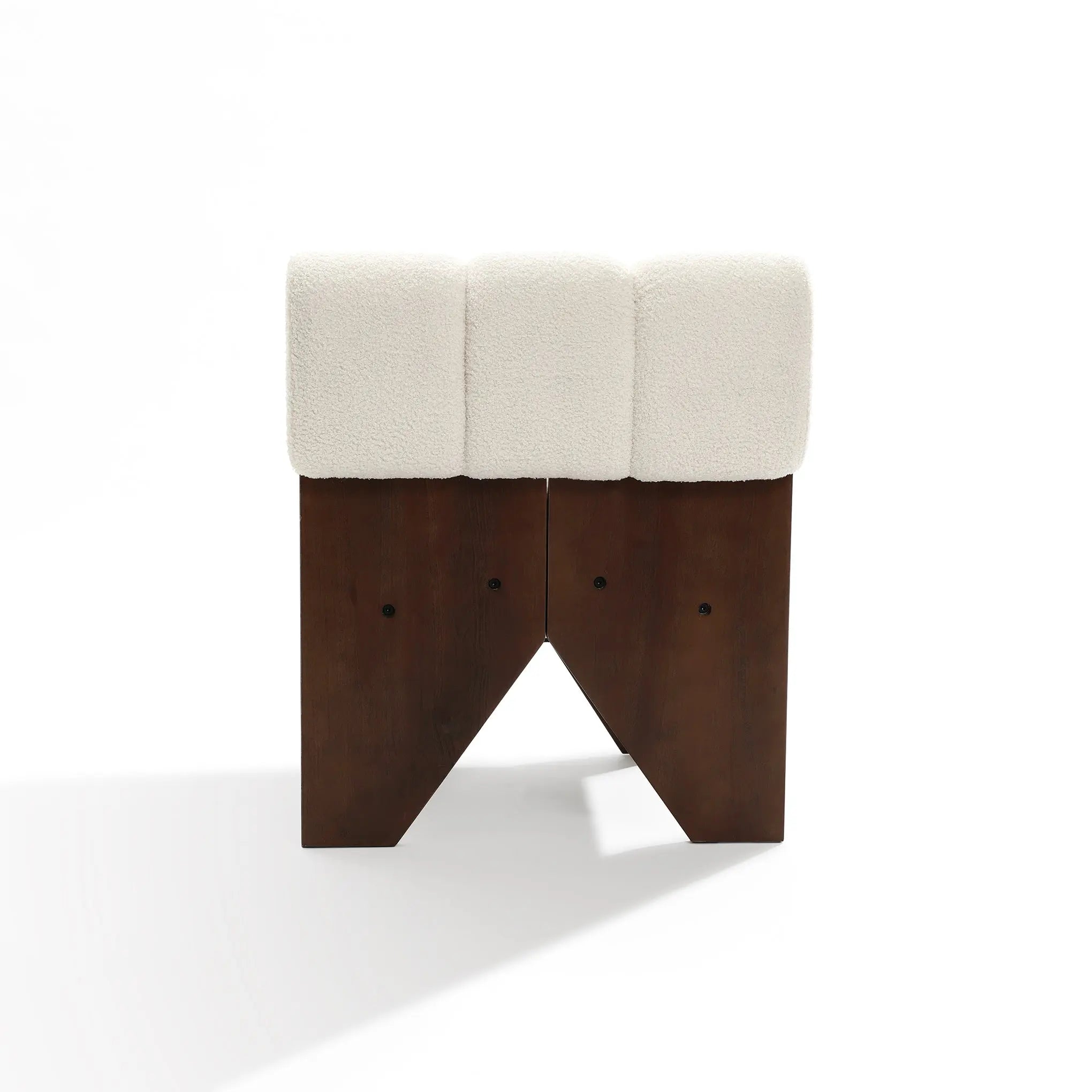 The Lorenzo boucle upholstered wood frame armless accent chair by LuxenHome features a dark wooden base with three distinct columns and a white cushioned top. The geometric cut-out base adds mid-century allure, while high-density foam ensures comfort. Presentation in front of a plain white background.