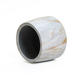 A cylindrical, light wood vase with a smooth surface and subtle marble texture rests sideways against a pristine white background.