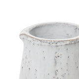Close-up of a white ceramic vase with a speckled texture, reminiscent of a vintage design, and featuring a flared rim that adds rustic charm.