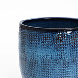 A close-up of LuxenHomes Ocean blue glazed round ceramic planter, standing 11.22 tall, reveals its dappled pattern and glossy finish with a stunning gradient color against a plain white background.