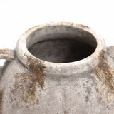 Close-up of an aged, weathered terracotta jug vase with a wide opening and small handles on a white background, exuding vintage appeal.