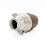 The LuxenHome Rustic Cream and Brown Terracotta Urn Vase, 18.5 h, features a rounded body with two handles and a wide opening. Its textured surface in beige and brown highlights its rustic elegance, showcasing artisanal craftsmanship as it rests on its side facing left.