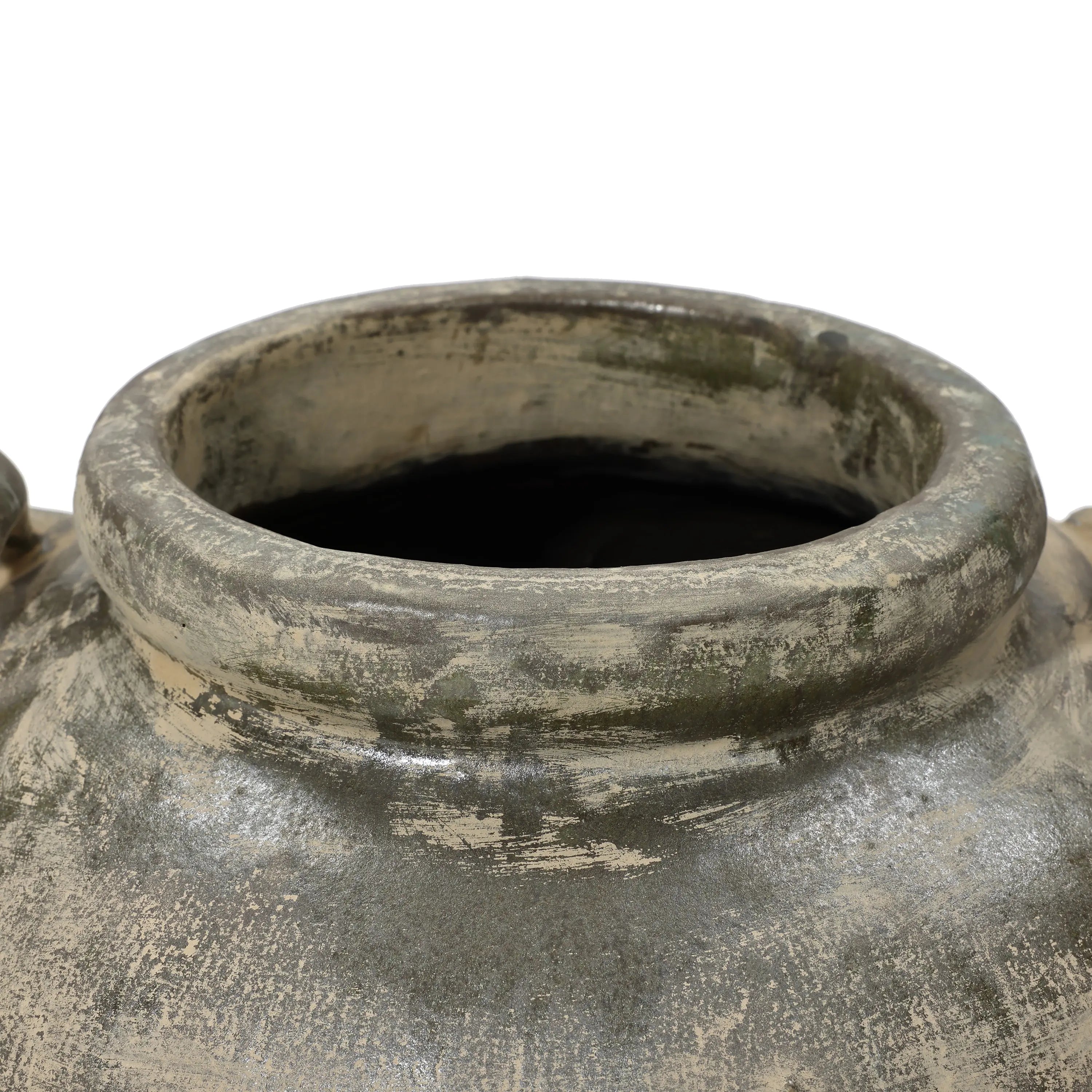 A close-up of the Fou antique terracotta vase by LuxenHome shows a rustic rim with a weathered, gray pottery finish and greenish hues, giving it an aged appearance. The pots opening reveals a dark interior.