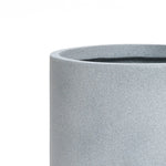 A modern minimalist gray cylindrical stone planter with a smooth, textured surface, perfect for indoor and outdoor decor, set against a plain white background.