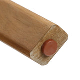 Close-up view of the end of a wooden furniture leg, crafted from FSC-certified Acacia wood, featuring a round brown protective cap.