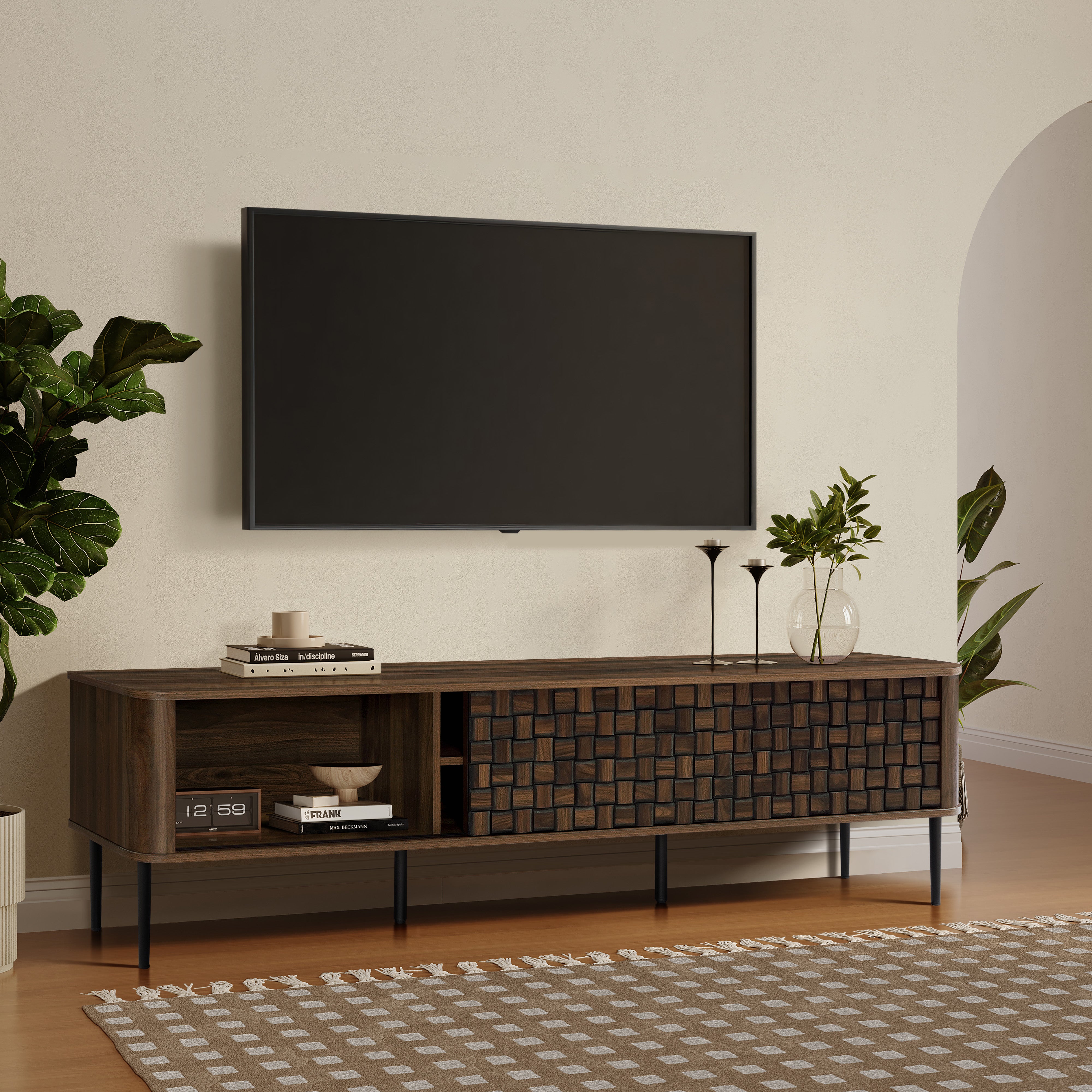 Modern living room with a mid-century modern TV console table, decorated with plants, candles, books.