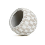 The LuxenHome White and Beige Geometric Patterned Round Planter, 11.81 H, features a textured ceramic design with diamond shapes and is crafted from durable MgO and fiberglass, elegantly tilted against a plain white background.