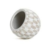 The LuxenHome White and Beige Geometric Patterned Round Planter, 11.81 H, features a textured ceramic design with diamond shapes and is crafted from durable MgO and fiberglass, elegantly tilted against a plain white background.